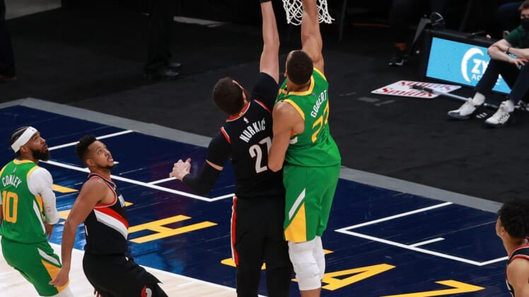 Apr 8, 2021; Salt Lake City, Utah, USA; Utah Jazz center Rudy Gobert (27) taps the ball in for a basket against Portland Trail Blazers center Jusuf Nurkic (27) during the second quarter at Vivint Smart Home Arena. Mandatory Credit: Chris Nicoll-USA TODAY Sports