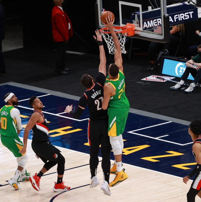 Apr 8, 2021; Salt Lake City, Utah, USA; Utah Jazz center Rudy Gobert (27) taps the ball in for a basket against Portland Trail Blazers center Jusuf Nurkic (27) during the second quarter at Vivint Smart Home Arena. Mandatory Credit: Chris Nicoll-USA TODAY Sports