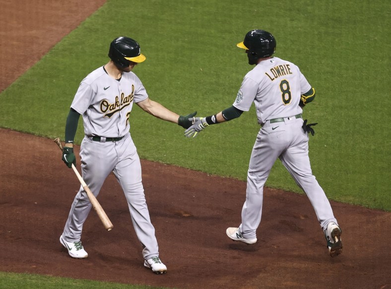 Apr 9, 2021; Houston, Texas, USA; Oakland Athletics second baseman Jed Lowrie (8) celebrates with first baseman Matt Olson (28) after hitting a home run during the fourth inning against the Houston Astros at Minute Maid Park. Mandatory Credit: Troy Taormina-USA TODAY Sports