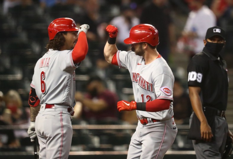 Apr 9, 2021; Phoenix, Arizona, USA; Cincinnati Reds outfielder Tyler Naquin (right) celebrates with Jonathan India after hitting a solo home run in the fourth inning against the Arizona Diamondbacks during opening day at Chase Field. Mandatory Credit: Mark J. Rebilas-USA TODAY Sports