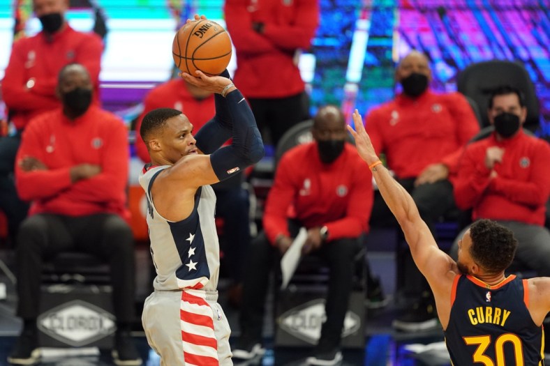 Apr 9, 2021; San Francisco, California, USA; Washington Wizards guard Russell Westbrook (4) shoots over Golden State Warriors guard Stephen Curry (30) during the second quarter at Chase Center. Mandatory Credit: Darren Yamashita-USA TODAY Sports