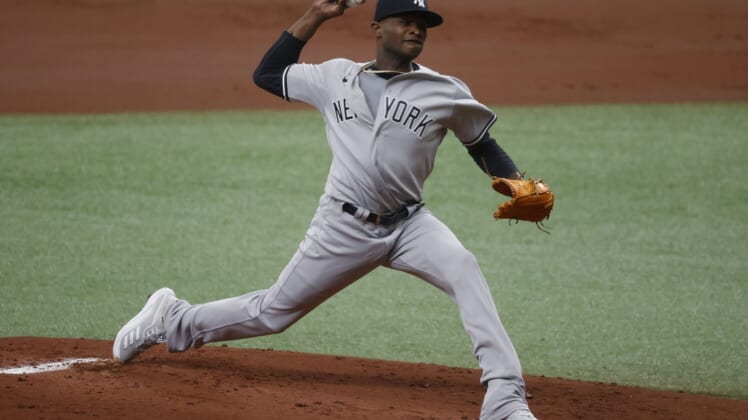 Apr 10, 2021; St. Petersburg, Florida, USA; New York Yankees starting pitcher Domingo German (55) throws a pitch during the first inning against the Tampa Bay Rays at Tropicana Field. Mandatory Credit: Kim Klement-USA TODAY Sports