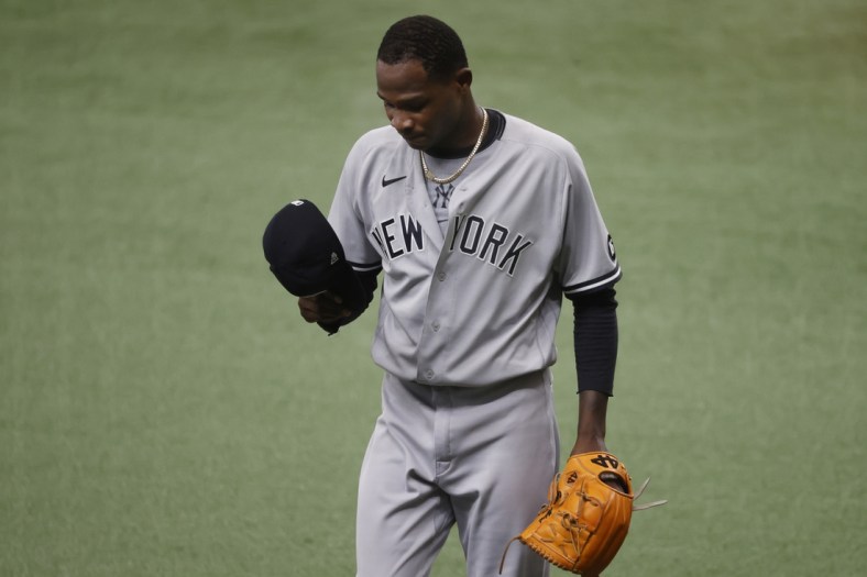 Apr 10, 2021; St. Petersburg, Florida, USA;  New York Yankees starting pitcher Domingo German (55) looks down at the end of the first inning against the Tampa Bay Rays wat Tropicana Field. Mandatory Credit: Kim Klement-USA TODAY Sports