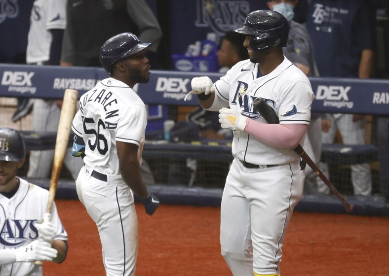 Apr 10, 2021; St. Petersburg, Florida, USA; Tampa Bay Rays left fielder Randy Arozarena (56) is congratulated by  first baseman Yandy D az (R) after hitting a home run during the third inning against the New York Yankees at Tropicana Field. Mandatory Credit: Kim Klement-USA TODAY Sports