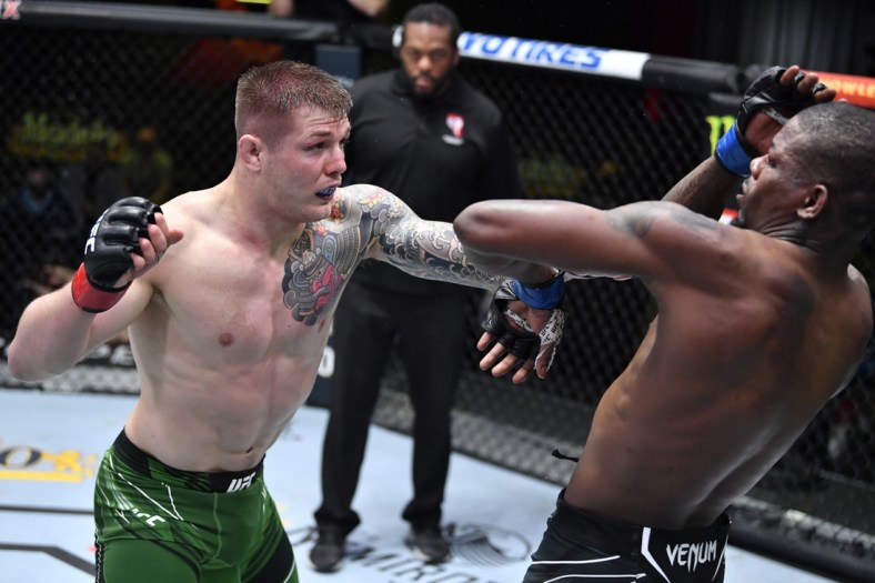 April 10, 2021; Las Vegas, NV, USA;   Marvin Vettori of Italy punches Kevin Holland in a middleweight fight during the UFC Fight Night event at UFC APEX on April 10, 2021 in Las Vegas, Nevada. Mandatory Credit: Chris Unger/Handout Photo via USA TODAY Sports