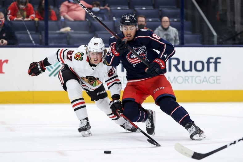 Apr 10, 2021; Columbus, Ohio, USA; Columbus Blue Jackets right winger Kole Sherwood (88) battles for the puck against Chicago Blackhawks defenseman Adam Boqvist (27) in the first period at Nationwide Arena. Mandatory Credit: Aaron Doster-USA TODAY Sports