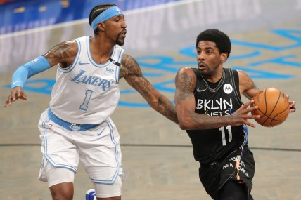 Apr 10, 2021; Brooklyn, New York, USA; Brooklyn Nets point guard Kyrie Irving (11) moves to the basket against Los Angeles Lakers shooting guard Kentavious Caldwell-Pope (1) during the first quarter at Barclays Center. Mandatory Credit: Brad Penner-USA TODAY Sports