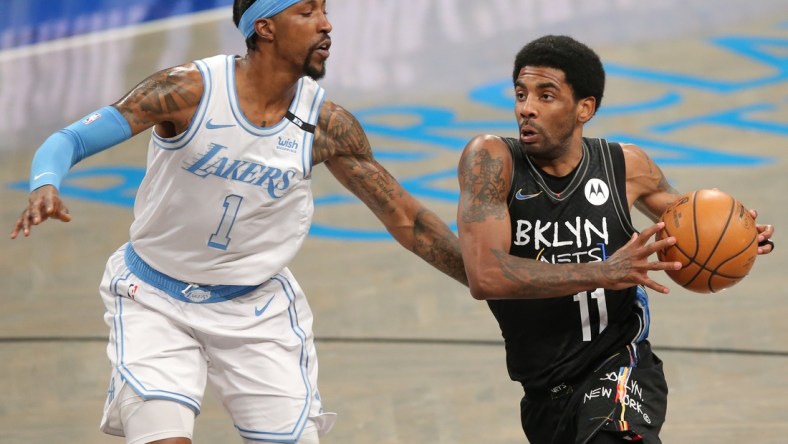 Apr 10, 2021; Brooklyn, New York, USA; Brooklyn Nets point guard Kyrie Irving (11) moves to the basket against Los Angeles Lakers shooting guard Kentavious Caldwell-Pope (1) during the first quarter at Barclays Center. Mandatory Credit: Brad Penner-USA TODAY Sports