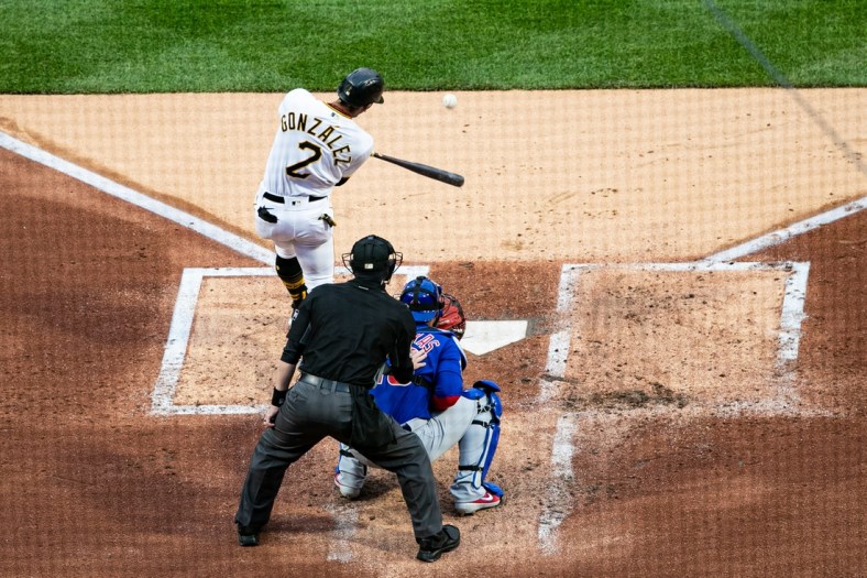Apr 10, 2021; Pittsburgh, Pennsylvania, USA; Pittsburgh Pirates second baseman Erik Gonzalez (2) hits an RBI double against the Chicago Cubs at PNC Park. Mandatory Credit: Mark Alberti-USA TODAY Sports