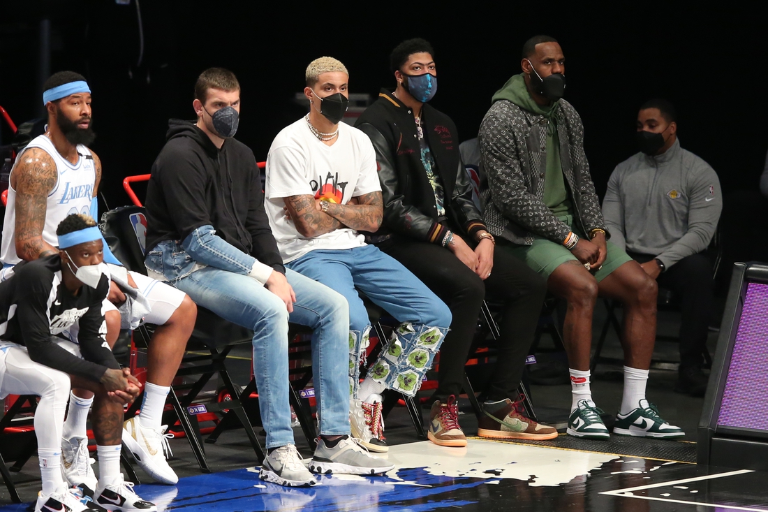 Apr 10, 2021; Brooklyn, New York, USA; Los Angeles Lakers center Marc Gasol (14) and small forward Kyle Kuzma (0) and power forward Anthony Davis (3) and small forward LeBron James (23) watch from the bench during the first quarter against the Brooklyn Nets at Barclays Center. Mandatory Credit: Brad Penner-USA TODAY Sports