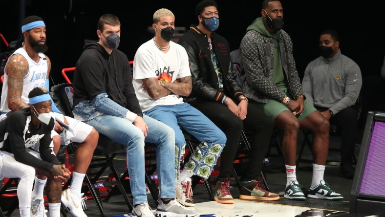 Apr 10, 2021; Brooklyn, New York, USA; Los Angeles Lakers center Marc Gasol (14) and small forward Kyle Kuzma (0) and power forward Anthony Davis (3) and small forward LeBron James (23) watch from the bench during the first quarter against the Brooklyn Nets at Barclays Center. Mandatory Credit: Brad Penner-USA TODAY Sports