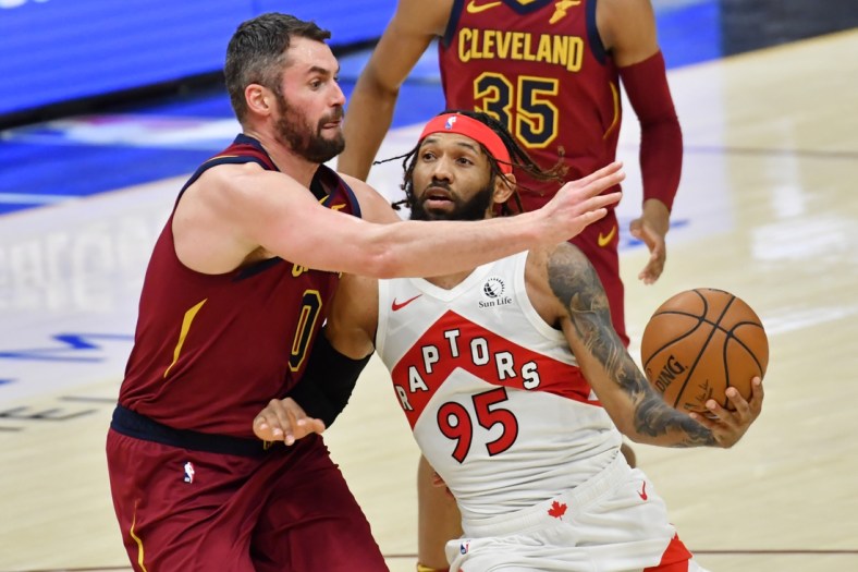 Apr 10, 2021; Cleveland, Ohio, USA; Toronto Raptors guard DeAndre' Bembry (95) moves to the basket against Cleveland Cavaliers forward Kevin Love (0) during the third quarter at Rocket Mortgage FieldHouse. Mandatory Credit: Ken Blaze-USA TODAY Sports