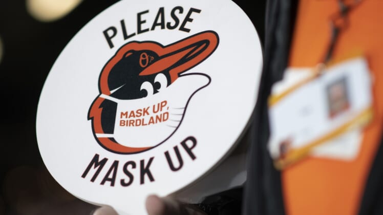 Apr 10, 2021; Baltimore, Maryland, USA; A detailed view of a sign    Please Mask Up    during the game between the Baltimore Orioles and the Boston Red Sox  at Oriole Park at Camden Yards. Mandatory Credit: Tommy Gilligan-USA TODAY Sports