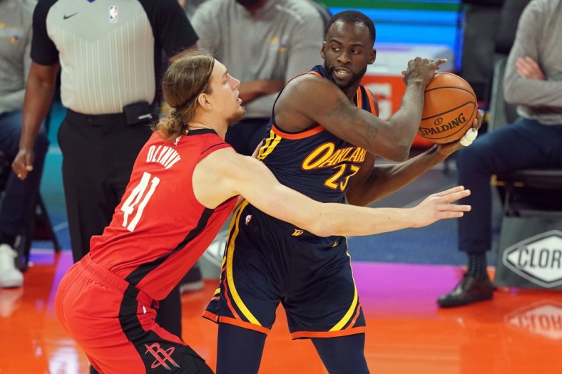 Apr 10, 2021; San Francisco, California, USA; Golden State Warriors forward Draymond Green (23) handles the ball while being defended by Houston Rockets forward Kelly Olynyk (41) during the first quarter at Chase Center. Mandatory Credit: Darren Yamashita-USA TODAY Sports