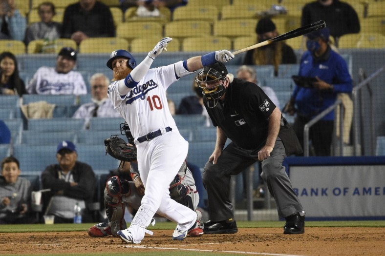 Apr 10, 2021; Los Angeles, California, USA; Los Angeles Dodgers third baseman Justin Turner (10) follows through on a swing for an RBI double during the fifth inning against the Washington Nationals at Dodger Stadium. Mandatory Credit: Kelvin Kuo-USA TODAY Sports