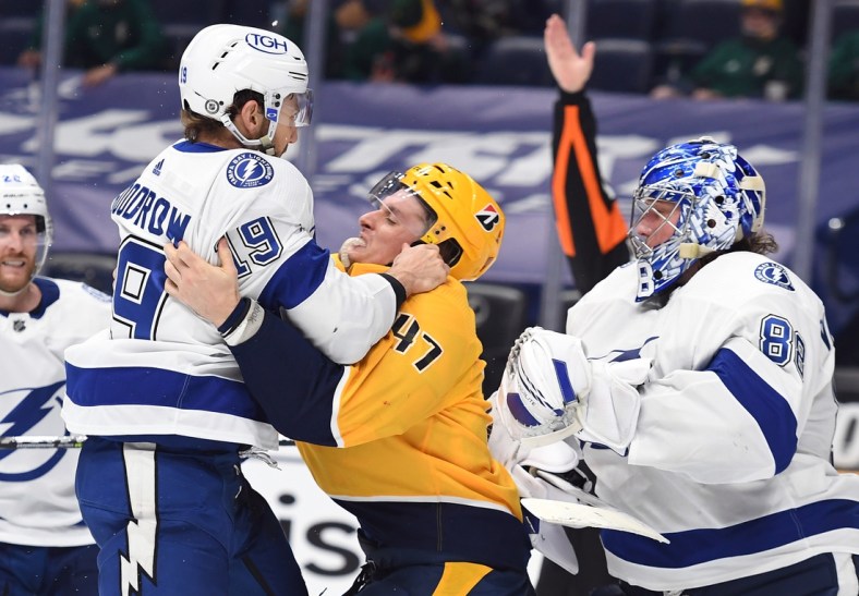 Apr 10, 2021; Nashville, Tennessee, USA; Tampa Bay Lightning right wing Barclay Goodrow (19) confronts Nashville Predators right wing Michael McCarron (47)  in the third period at Bridgestone Arena. Mandatory Credit: Christopher Hanewinckel-USA TODAY Sports