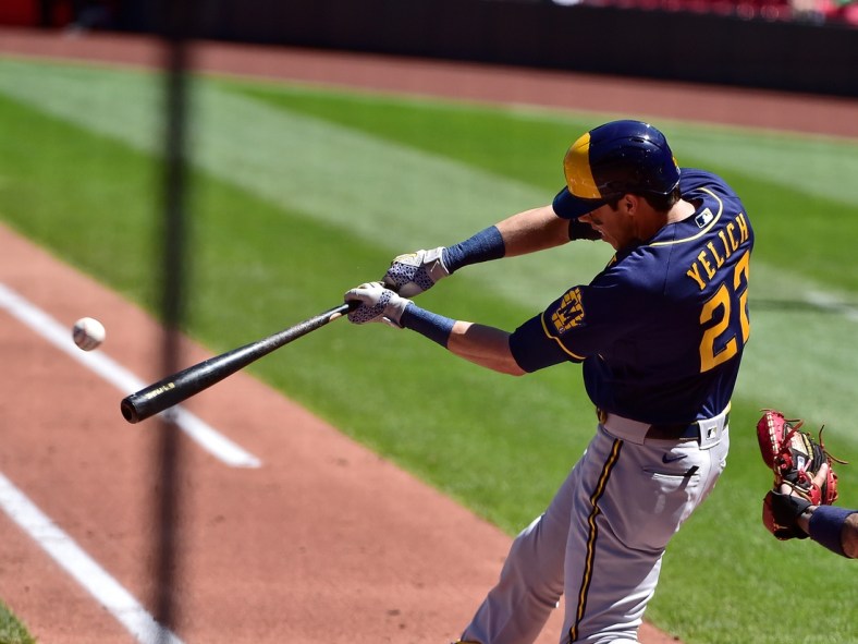 Apr 11, 2021; St. Louis, Missouri, USA;  Milwaukee Brewers left fielder Christian Yelich (22) hits a single off of St. Louis Cardinals starting pitcher Daniel Ponce de Leon (not pictured) during the second inning at Busch Stadium. Mandatory Credit: Jeff Curry-USA TODAY Sports