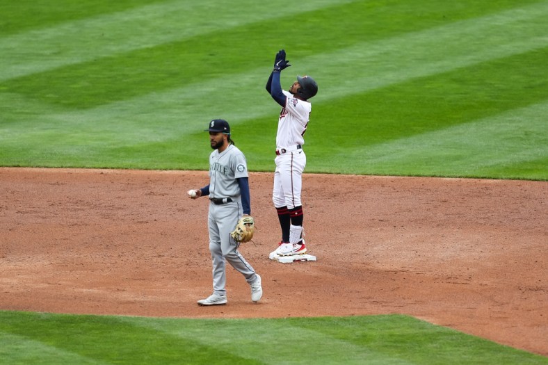 Apr 11, 2021; Minneapolis, Minnesota, USA; Minnesota Twins center fielder Byron Buxton (25) celebrates after hitting an RBI double in the third inning while Seattle Mariners shortstop J.P. Crawford (3) looks on at Target Field. Mandatory Credit: David Berding-USA TODAY Sports