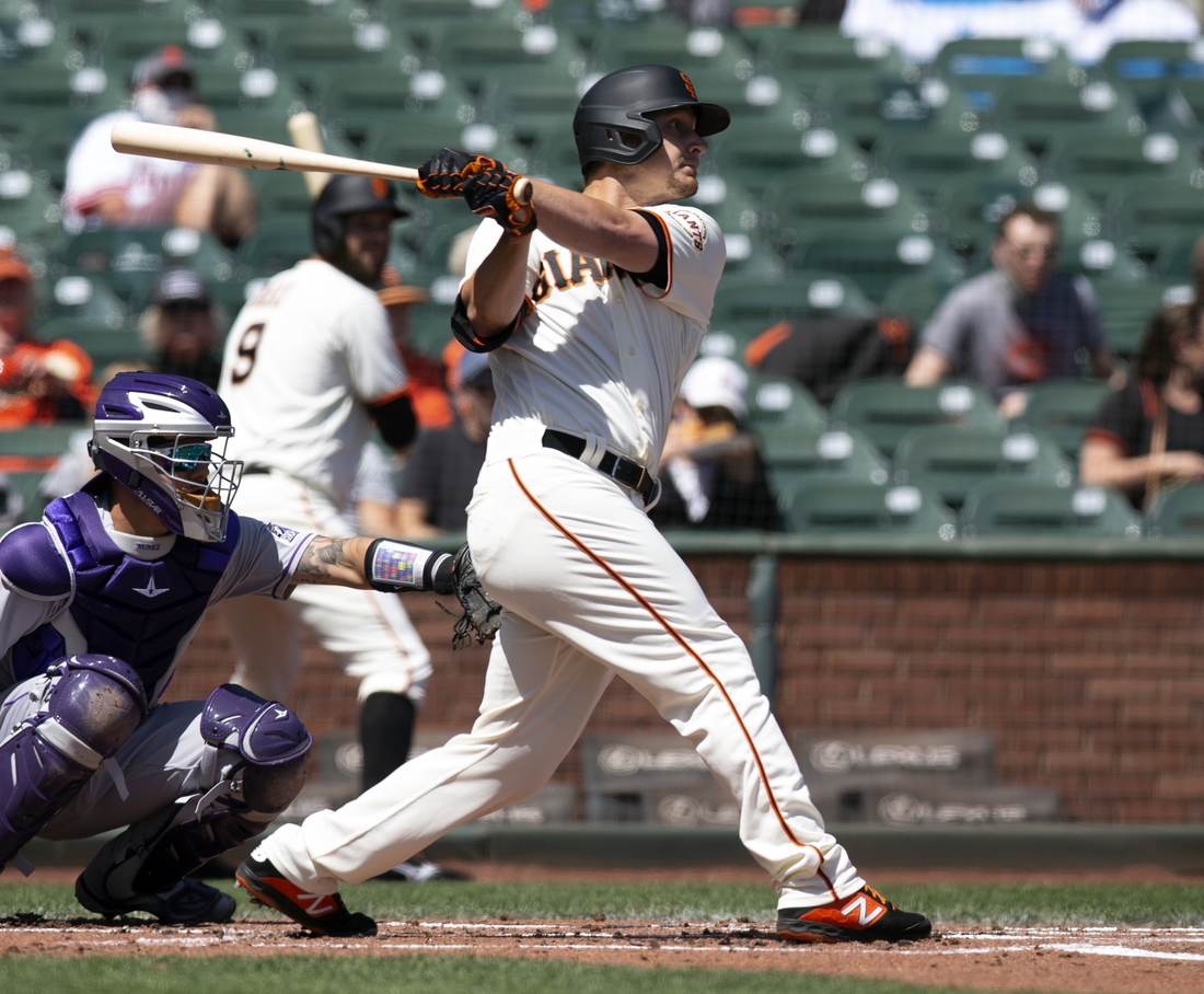 Apr 11, 2021; San Francisco, California, USA; San Francisco Giants batter Alex Dickerson (12) follows through on his solo home run again the Colorado Rockies during the first inning of a Major League Baseball game at Oracle Park. Mandatory Credit: D. Ross Cameron-USA TODAY Sports