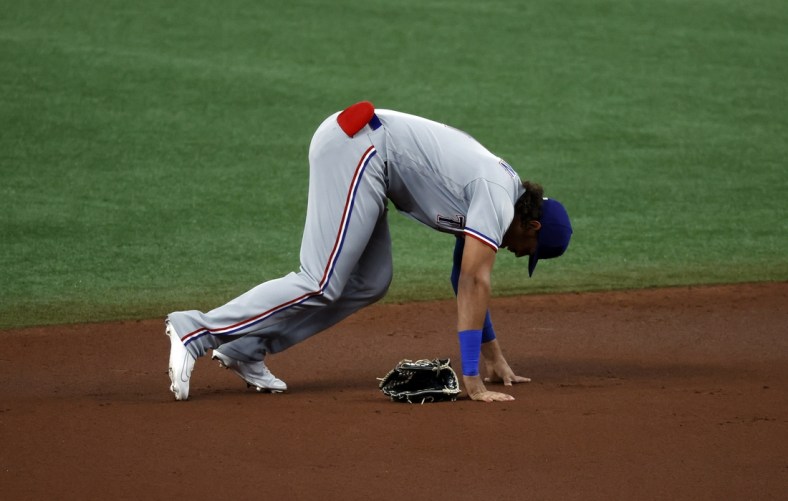 Apr 12, 2021; St. Petersburg, Florida, USA;  Texas Rangers left fielder Ronald Guzman (11) reacts after suffering an apparent injury during the first inning against the Tampa Bay Rays at Tropicana Field. Guzman left the game after the play. Mandatory Credit: Kim Klement-USA TODAY Sports