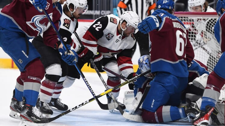 Apr 12, 2021; Denver, Colorado, USA; Arizona Coyotes left wing Johan Larsson (22) and right wing Conor Garland (83) attempt to score against Colorado Avalanche goaltender Philipp Grubauer (31) and defenseman Keaton Middleton (67) in the first period at Ball Arena. Mandatory Credit: Ron Chenoy-USA TODAY Sports
