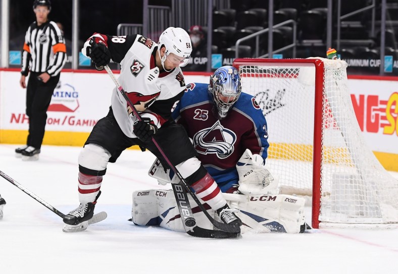 Apr 12, 2021; Denver, Colorado, USA; Arizona Coyotes left wing Michael Bunting (58) is unable to score against Colorado Avalanche goaltender Philipp Grubauer (31) in the third period at Ball Arena. Mandatory Credit: Ron Chenoy-USA TODAY Sports