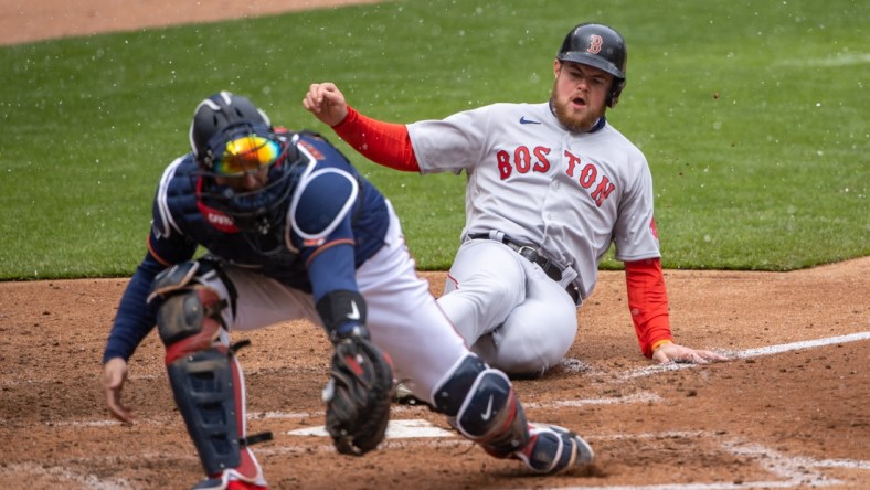 Apr 13, 2021; Minneapolis, Minnesota, USA; Boston Red Sox second baseman Christian Arroyo (39) slides safely into home plate before Minnesota Twins catcher Mitch Garver (8) can catch the ball and make a tag in the fifth inning at Target Field. Mandatory Credit: Jesse Johnson-USA TODAY Sports