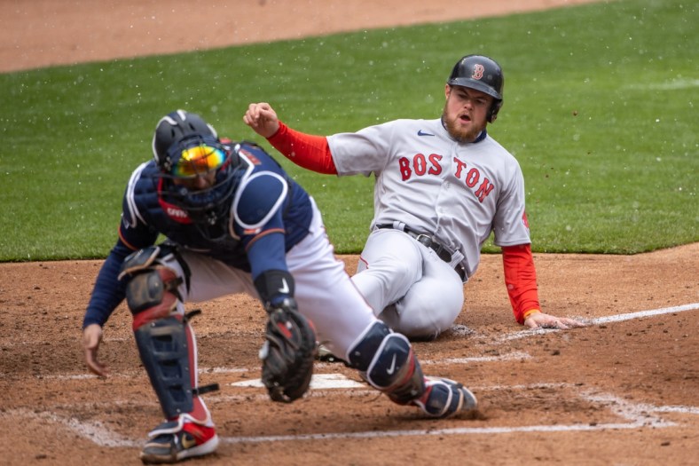 Apr 13, 2021; Minneapolis, Minnesota, USA; Boston Red Sox second baseman Christian Arroyo (39) slides safely into home plate before Minnesota Twins catcher Mitch Garver (8) can catch the ball and make a tag in the fifth inning at Target Field. Mandatory Credit: Jesse Johnson-USA TODAY Sports