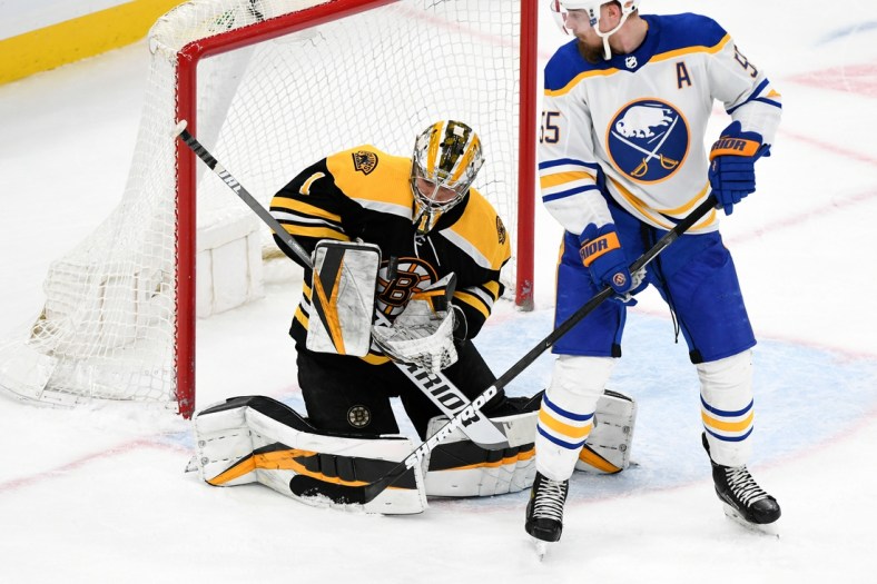Apr 13, 2021; Boston, Massachusetts, USA; Boston Bruins goaltender Jeremy Swayman (1) makes a save in front of Buffalo Sabres defenseman Rasmus Ristolainen (55) during the first period at TD Garden. Mandatory Credit: Brian Fluharty-USA TODAY Sports