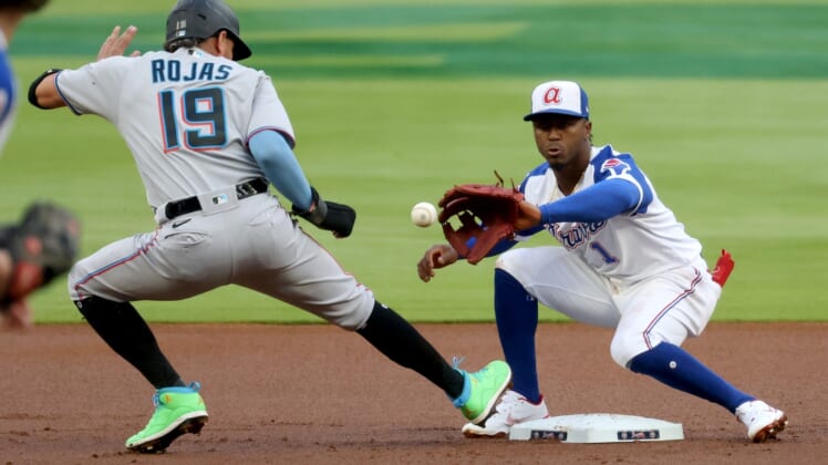 Apr 13, 2021; Atlanta, Georgia, USA; Miami Marlins shortstop Miguel Rojas (19) is safe at second base on a pickoff attempt by Atlanta Braves second baseman Ozzie Albies (1) during the first inning at Truist Park. Mandatory Credit: Jason Getz-USA TODAY Sports