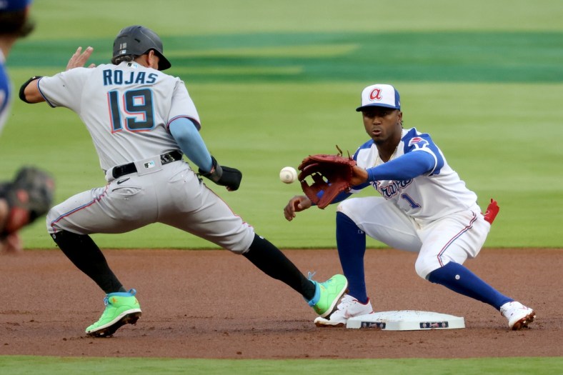 Apr 13, 2021; Atlanta, Georgia, USA; Miami Marlins shortstop Miguel Rojas (19) is safe at second base on a pickoff attempt by Atlanta Braves second baseman Ozzie Albies (1) during the first inning at Truist Park. Mandatory Credit: Jason Getz-USA TODAY Sports