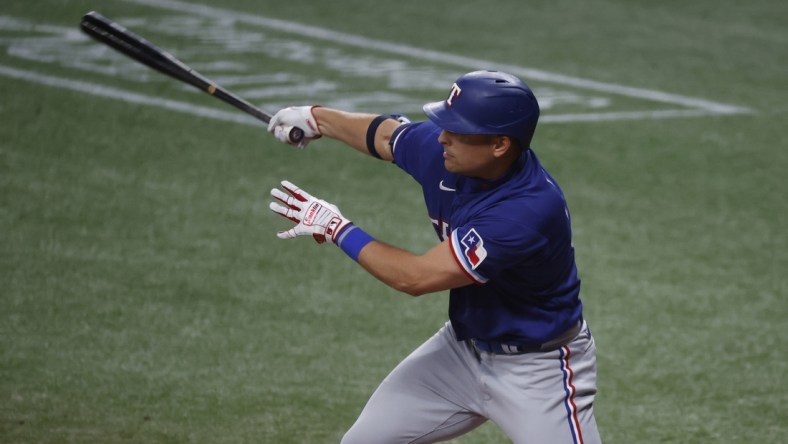 Apr 13, 2021; St. Petersburg, Florida, USA;  Texas Rangers first baseman Nate Lowe (30) singles against the Tampa Bay Rays during the fourth inning at Tropicana Field. Mandatory Credit: Kim Klement-USA TODAY Sports