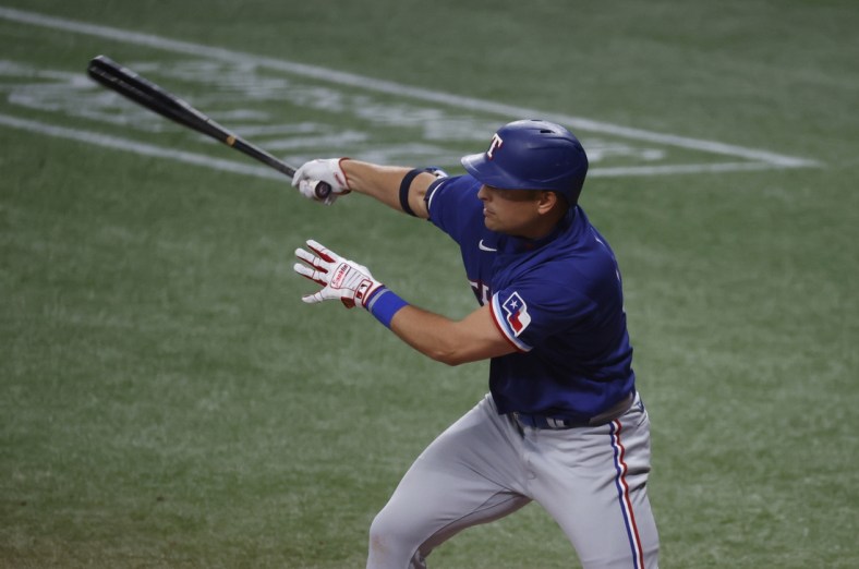 Apr 13, 2021; St. Petersburg, Florida, USA;  Texas Rangers first baseman Nate Lowe (30) singles against the Tampa Bay Rays during the fourth inning at Tropicana Field. Mandatory Credit: Kim Klement-USA TODAY Sports