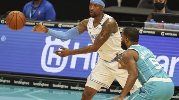 Apr 13, 2021; Charlotte, North Carolina, USA; Los Angeles Lakers guard Kentavious Caldwell-Pope (1) passes away from Charlotte Hornets guard Brad Wanamaker (9) during the first quarter at Spectrum Center. Mandatory Credit: Nell Redmond-USA TODAY Sports