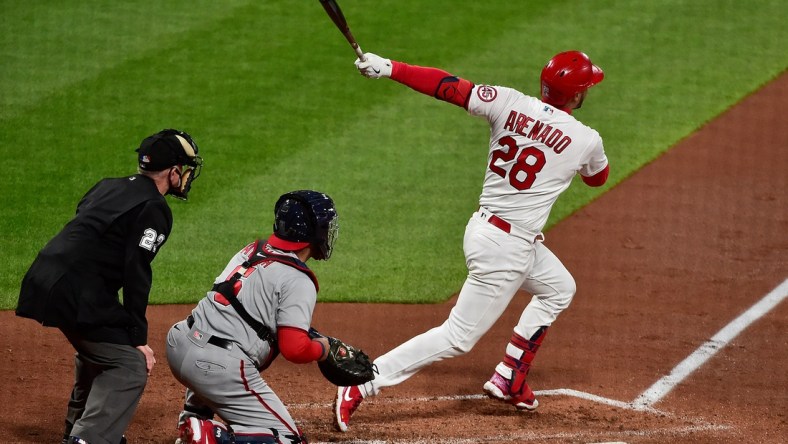 Apr 13, 2021; St. Louis, Missouri, USA;  St. Louis Cardinals third baseman Nolan Arenado (28) hits a two run home run during the third inning against the Washington Nationals at Busch Stadium. Mandatory Credit: Jeff Curry-USA TODAY Sports