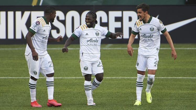 Apr 13, 2021; Portland, Oregon, USA; Portland Timbers forward Yimmi Chara (23) celebrates with teammates after scoring a goal during the second half against Marathon at Providence Park. Mandatory Credit: Troy Wayrynen-USA TODAY Sports