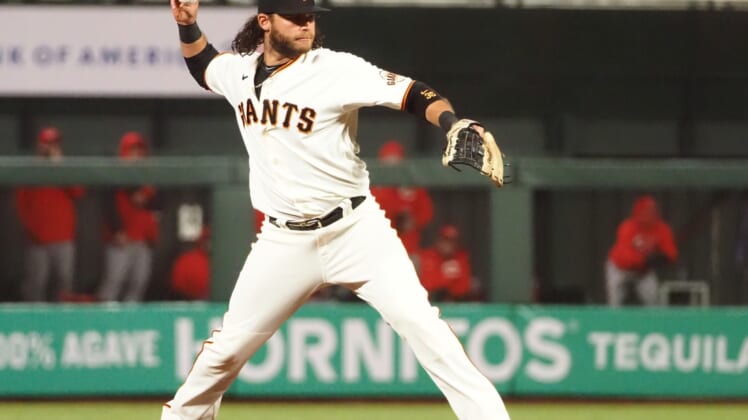 Apr 13, 2021; San Francisco, California, USA; San Francisco Giants shortstop Brandon Crawford (35) throws to first base against the Cincinnati Reds during the fifth inning at Oracle Park. Mandatory Credit: Kelley L Cox-USA TODAY Sports