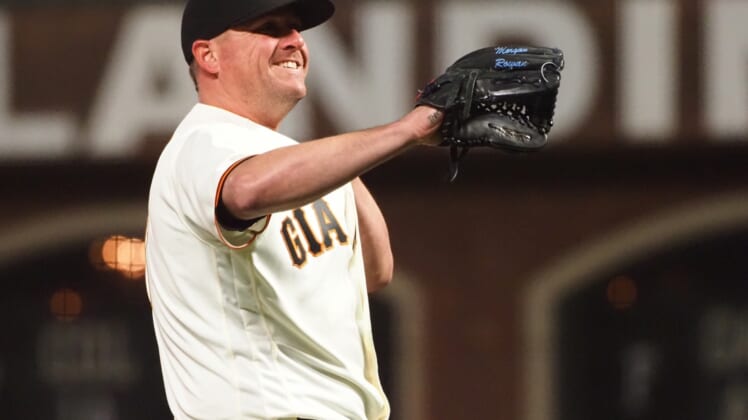 Apr 13, 2021; San Francisco, California, USA; San Francisco Giants relief pitcher Jake McGee (17) smiles between pitches against the Cincinnati Reds during the ninth inning at Oracle Park. Mandatory Credit: Kelley L Cox-USA TODAY Sports