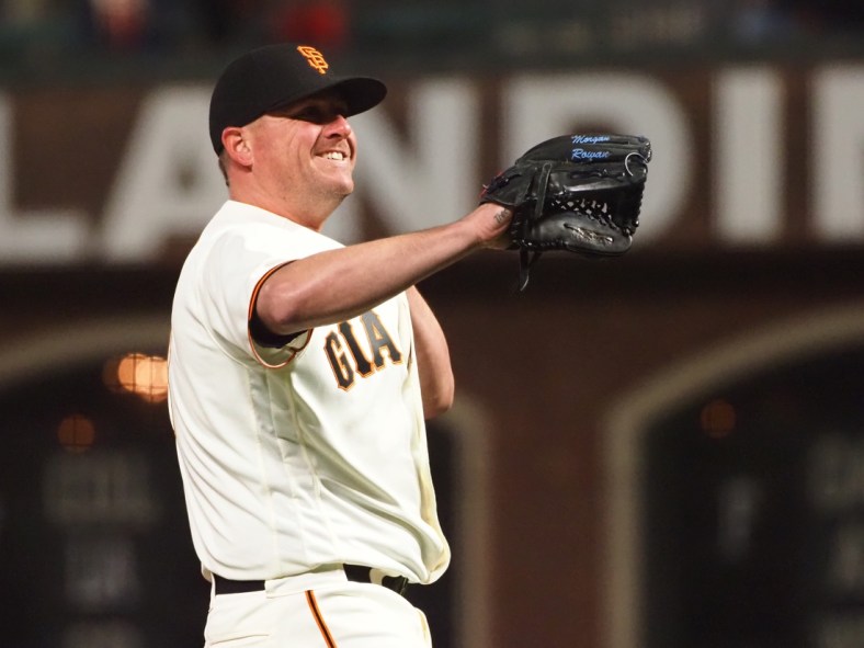 Apr 13, 2021; San Francisco, California, USA; San Francisco Giants relief pitcher Jake McGee (17) smiles between pitches against the Cincinnati Reds during the ninth inning at Oracle Park. Mandatory Credit: Kelley L Cox-USA TODAY Sports