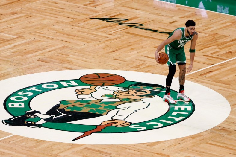 Apr 7, 2021; Boston, Massachusetts, USA; Boston Celtics forward Jayson Tatum (0) brings the ball up past half court over the Celtics logo during the third quarter against the New York Knicks at TD Garden. Mandatory Credit: Winslow Townson-USA TODAY Sports