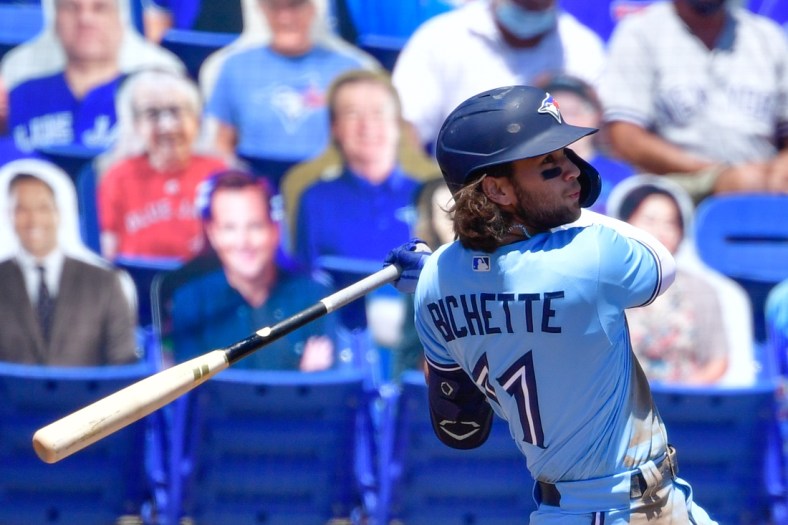 Apr 14, 2021; Dunedin, Florida, USA; Toronto Blue Jays shortstop Bo Bichette (11) hits a solo home run during the third inning against the New York Yankees at TD Ballpark. Mandatory Credit: Douglas DeFelice-USA TODAY Sports