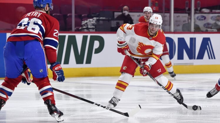 Apr 14, 2021; Montreal, Quebec, CAN; Calgary Flames forward Johnny Gaudreau (13) shoots the puck and Montreal Canadiens defenseman Jeff Petry (26) attempts to block during the first period at the Bell Centre. Mandatory Credit: Eric Bolte-USA TODAY Sports