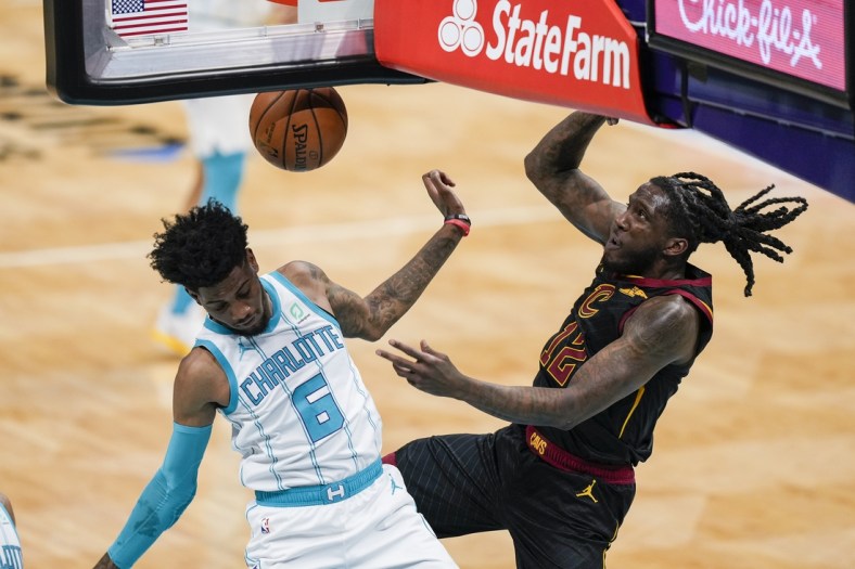 Apr 14, 2021; Charlotte, North Carolina, USA; Cleveland Cavaliers forward Taurean Prince (12) gets a dunk defended by Charlotte Hornets forward Jalen McDaniels (6) during the second quarter at the Spectrum Center. Mandatory Credit: Jim Dedmon-USA TODAY Sports