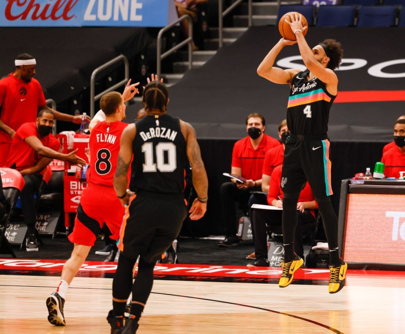 Apr 14, 2021; Tampa, Florida, USA;  San Antonio Spurs guard Derrick White (4) shoots from the three point line in the first quarter at Amalie Arena. Mandatory Credit: Nathan Ray Seebeck-USA TODAY Sports