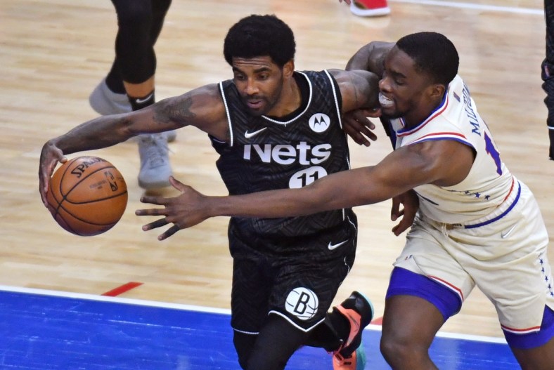 Apr 14, 2021; Philadelphia, Pennsylvania, USA; Brooklyn Nets guard Kyrie Irving (11) and Philadelphia 76ers guard Shake Milton (18) battle for the ball during the second quarter at Wells Fargo Center. Mandatory Credit: Eric Hartline-USA TODAY Sports