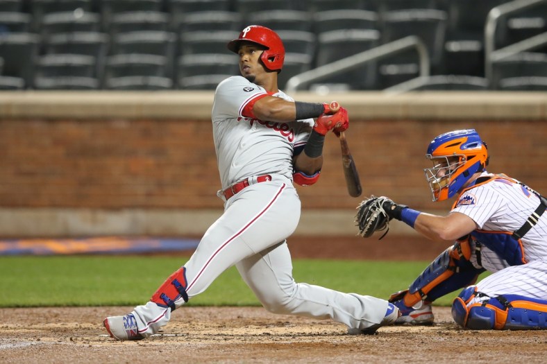 Apr 14, 2021; New York City, New York, USA; Philadelphia Phillies second baseman Jean Segura (2) follows through on a solo home run against the New York Mets during the fifth inning at Citi Field. Mandatory Credit: Brad Penner-USA TODAY Sports