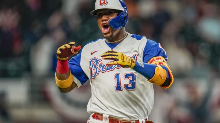Apr 14, 2021; Cumberland, Georgia, USA; Atlanta Braves right fielder Ronald Acuna Jr. (13) reacts after hitting a home run against the Miami Marlins during the seventh inning at Truist Park. Mandatory Credit: Dale Zanine-USA TODAY Sports