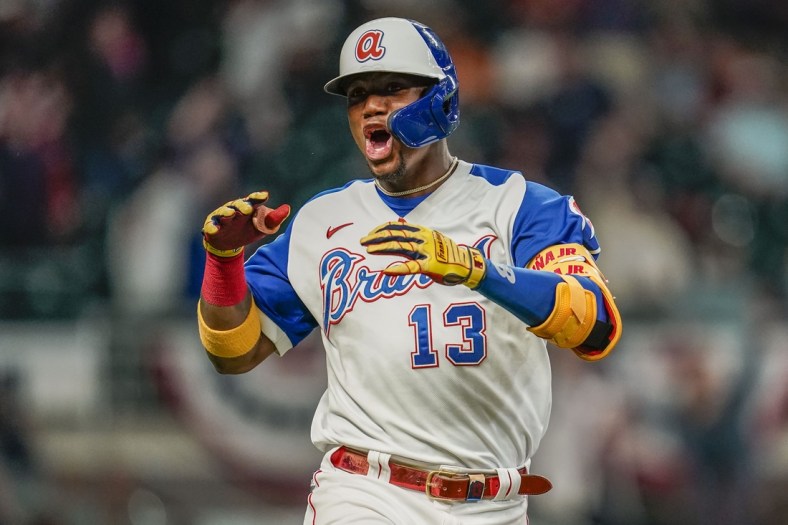 Apr 14, 2021; Cumberland, Georgia, USA; Atlanta Braves right fielder Ronald Acuna Jr. (13) reacts after hitting a home run against the Miami Marlins during the seventh inning at Truist Park. Mandatory Credit: Dale Zanine-USA TODAY Sports