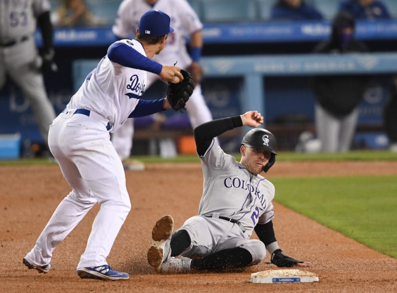 Apr 14, 2021; Los Angeles, California, USA;   Colorado Rockies shortstop Trevor Story (27) is out at second but Los Angeles Dodgers shortstop Corey Seager (5) is not able to complete the double play in the fifth inning of the game at Dodger Stadium. Mandatory Credit: Jayne Kamin-Oncea-USA TODAY Sports