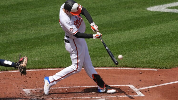 Apr 15, 2021; Baltimore, Maryland, USA; Baltimore Orioles outfielder Ryan Mountcastle (42) connects on a single in the first inning against the Seattle Mariners at Oriole Park at Camden Yards. Mandatory Credit: Mitch Stringer-USA TODAY Sports